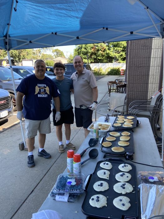 Massapequa Park Village Mayor Daniel Pearl (L.) and Oyster Bay Town Council Member Tom Hand (R.) making pancakes during the breakfast.