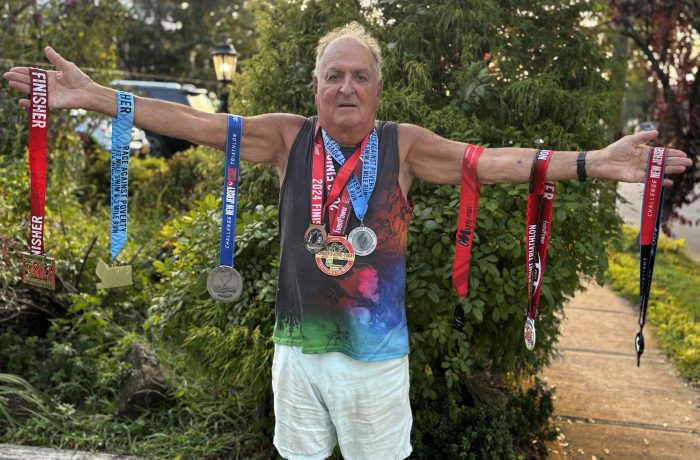 Alan End, 83, stands with medals he's earned at recent races.