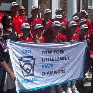 St. James/Smithtown Bulls celebrate their first New York State Little League championship outside Smithtown Town Hall on Sunday, Aug. 20, 2025 (Matthew Page)