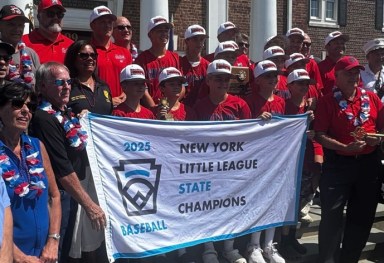 St. James/Smithtown Bulls celebrate their first New York State Little League championship outside Smithtown Town Hall on Sunday, Aug. 20, 2025 (Matthew Page)