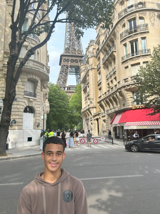 Brent Costello stands in front of the Eiffel Tower in Paris, where this year's International History Olympiad was held