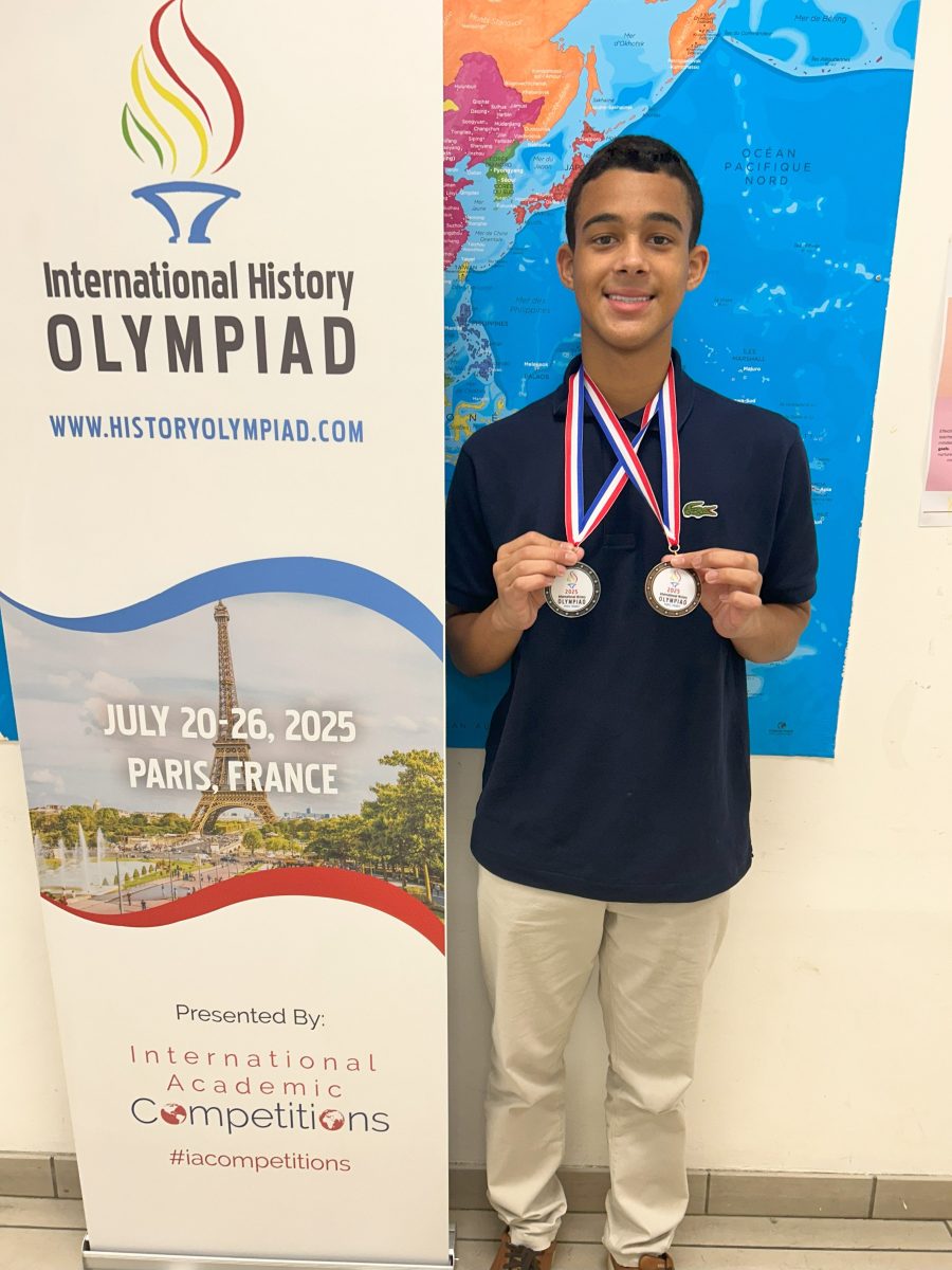 Incoming Jericho high schooler Brent Costello showcases the two medals he earned at the 2025 International History Olympiad.