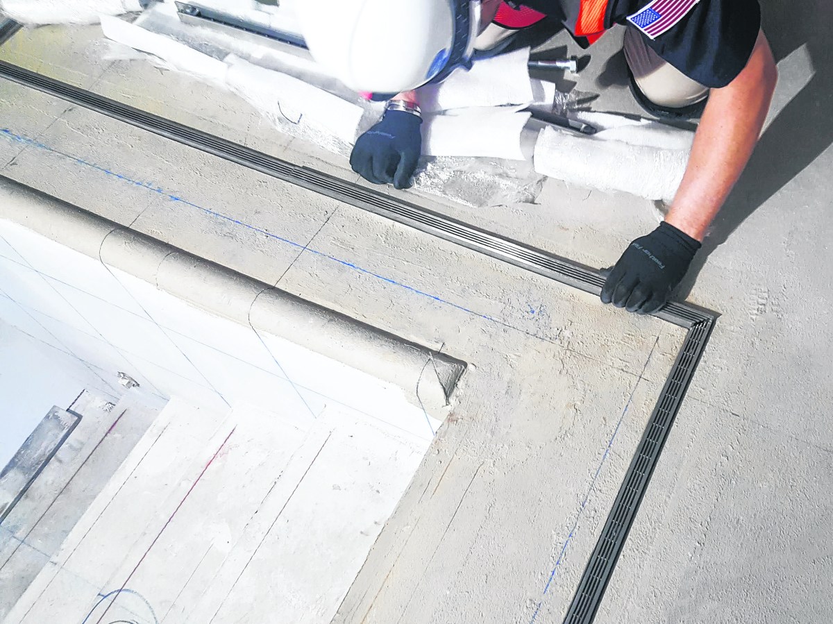 An Infinity Drain custom pool drain being installed.