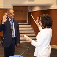 Port Washington's new superintendent, Gaurav Passi (left), was sworn into office by Deputy District Clerk Denise Attonito (right).
