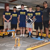 Technology teacher Matthew Swanson and high school Robotics Team members Ethan Simon, Thomas Flynn, Caiden Kacharaba, Dylan Raghubeer and Robert Meilak (L. to R.) at Massapequa's robotics camp