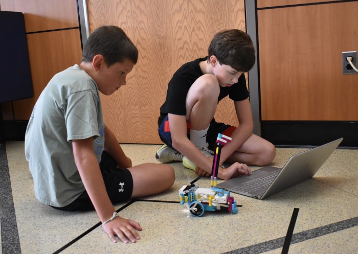 Lucas Vanderberg (L.) and Matthew Klarmann (R.) getting ready to test their robot.