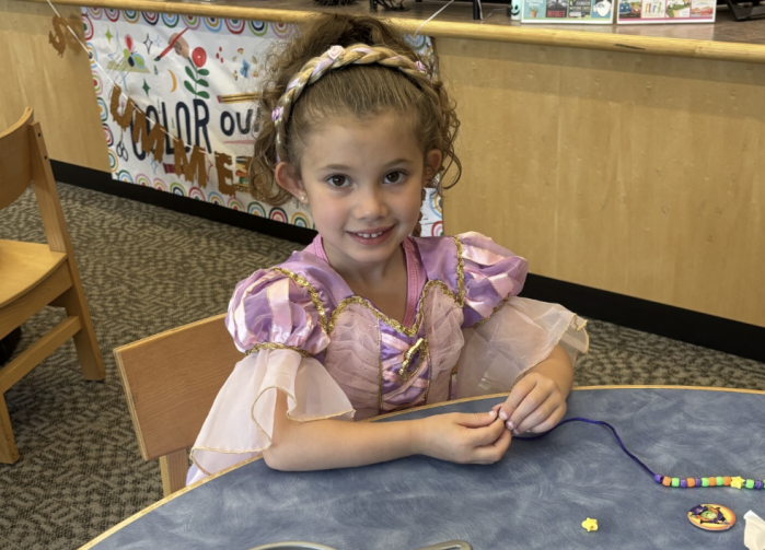 Kids complete arts and crafts in costume at the library.