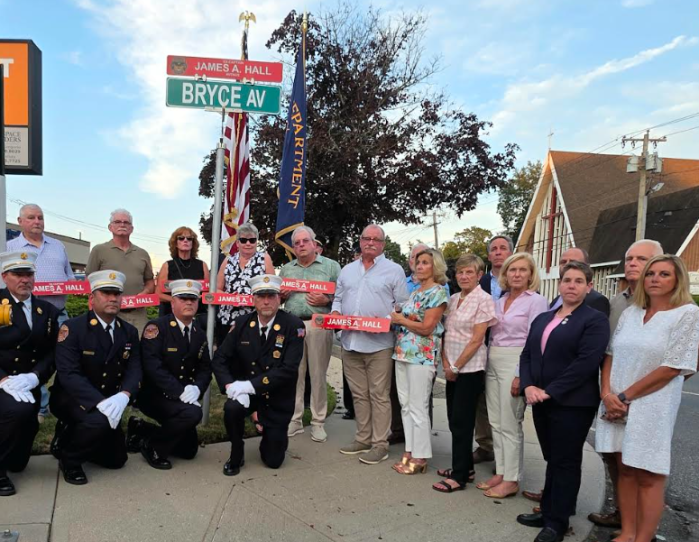 James Hall's family stand with elected officials and Glen Cove Fire Chiefs at the street renaming ceremony.