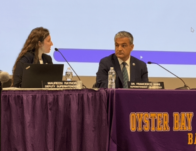 Oyster Bay-East Norwich Superintendent Francesco Ianni (R.) tells resident Ann Marie Longo that his goals are "internal."