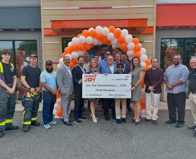 Dunkin in Roslyn Heights reopened with a donation from Metro Franchising, with Nassau County officials joining the celebration.