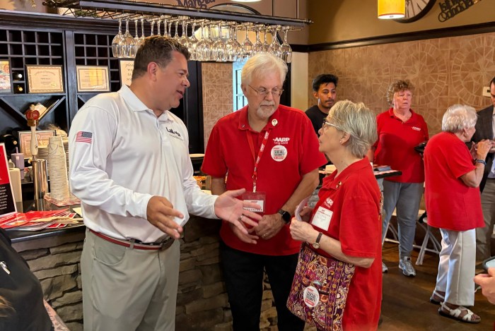 LaLota listened to AARP Long Island volunteers (Jeff Dubitsky and Ann Dubitsky) and residents’ stories on how the program has shaped their lives at a Pizza Pop-Up in Mama Bella’s in Medford.