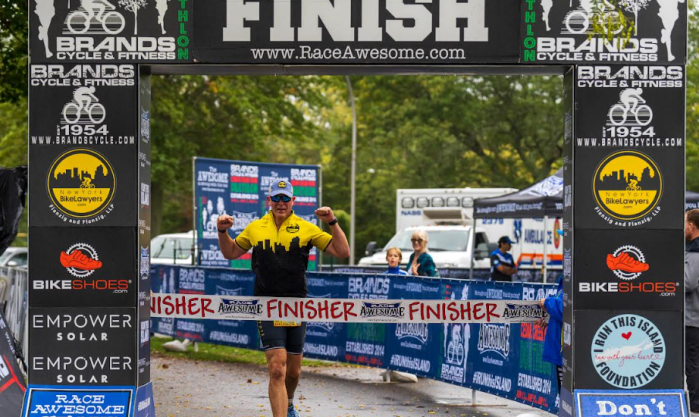 Sea Cliff Triathlon organizer Daniel Flanzig at the finish line of a former Race Awesome event.
