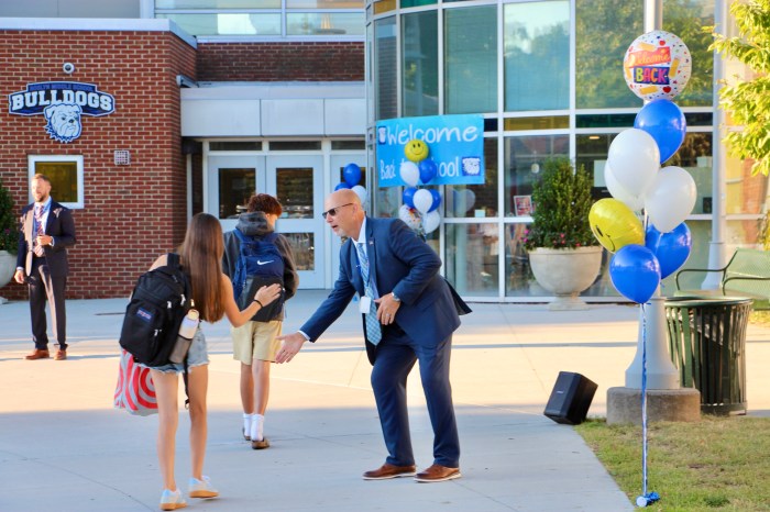 Roslyn Middle School Principal Craig Johanson welcomes students back to school.
