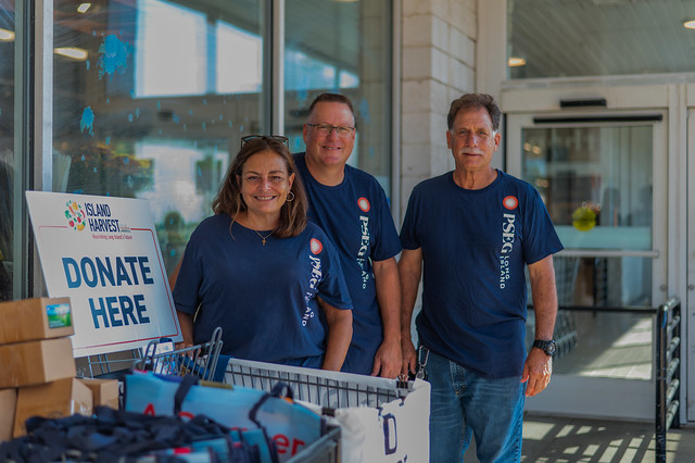PSEG employee volunteers encourage shoppers to donate to the company's Power to Feed Long Island initiative this summer.