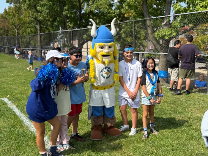 The Schreiber High School mascot took pictures with community members.