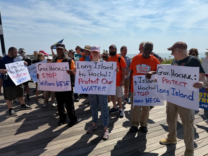 Protestors took to the Long Beach boardwalk to call on Gov. Kathy Hochul to put an end to fossil-fuel projects.