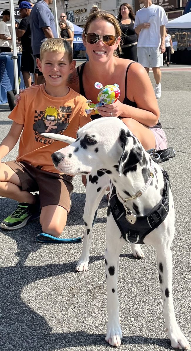 Last year's Glen Cove street fair attendees enjoy ices with their furry friend