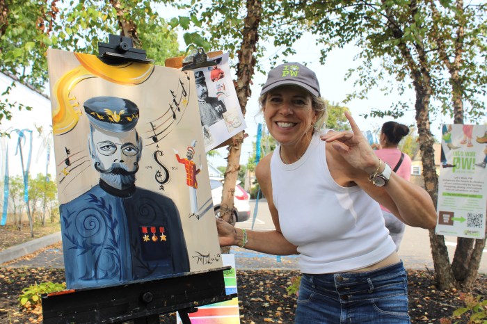 Port Washington resident Michelle Shain with her live painting during the Art Walk event.