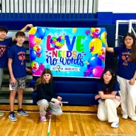 Volunteers with the Manhasset Aces Adaptive Tennis program promote autism awareness.