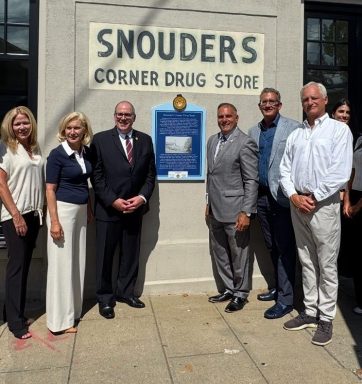 Oyster Bay Town Supervisor Joseph Saladino (C. R.) unveils a historic marker at 108 South St. in downtown Oyster Bay.