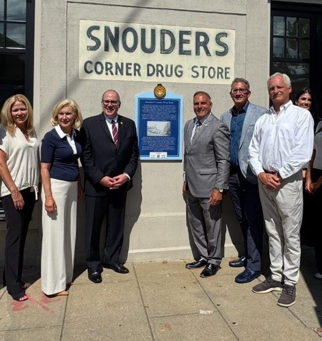Oyster Bay Town Supervisor Joseph Saladino (C. R.) unveils a historic marker at 108 South St. in downtown Oyster Bay.