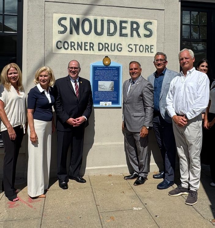 Oyster Bay Town Supervisor Joseph Saladino (C. R.) unveils a historic marker at 108 South St. in downtown Oyster Bay.