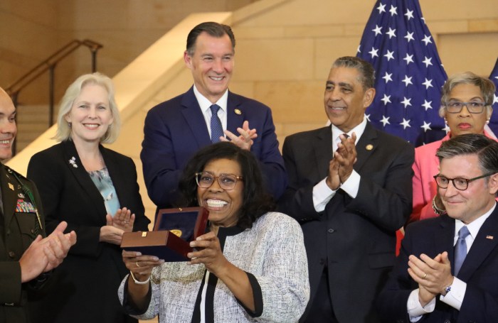 Oyster Bay native Debra Willet (C.) accepts the Congressional Gold Medal on behalf of the Harlem Hellfighters.