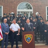 U.S. Rep. Tom Suozzi (C.) and Glen Cove Police Chief William Whitton (C. L.) recognize six Glen Cove police officer for their response to an apartment fire on April 17