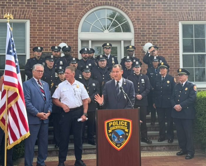 U.S. Rep. Tom Suozzi (C.) and Glen Cove Police Chief William Whitton (C. L.) recognize six Glen Cove police officer for their response to an apartment fire on April 17