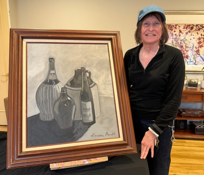 Lorraine Arroll created a grayscale painting of vases and bottles at an art studio. 