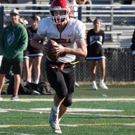Mineola High School quarterback Gavin McLaughlin running with the football.