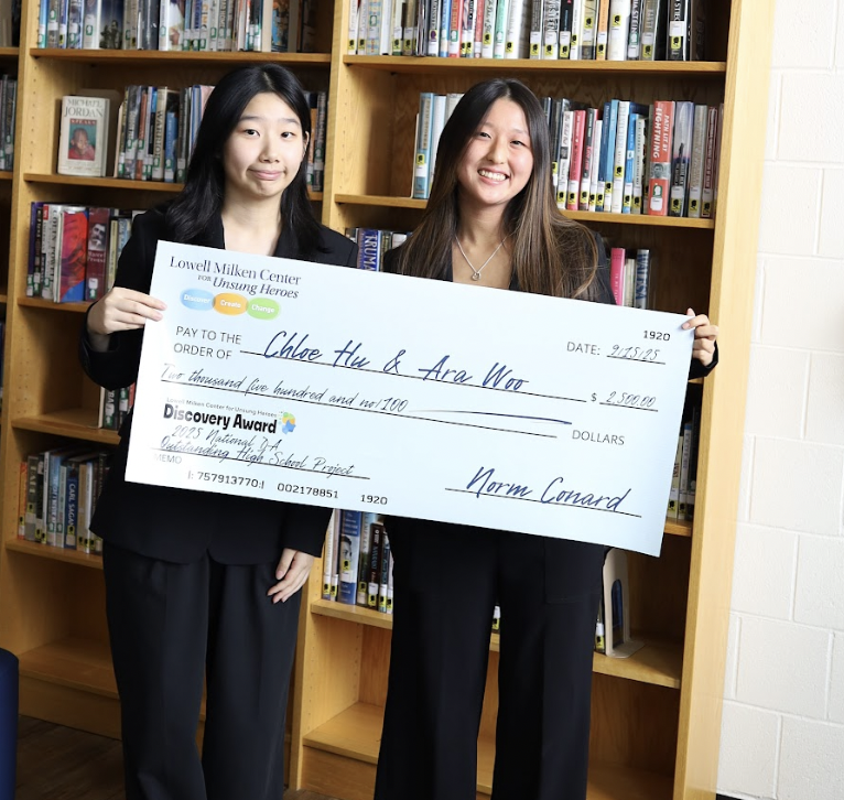 Ara Woo (L.) and Chloe Hu (R.) receive the $2,500 Outstanding High School Project Award from the Lowell Milken Center.