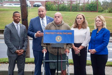 Carrié Solages, Seth Koslow, Carlos Vasquez, Delia DeRiggi-Whitton, and Debra Mulé (L. to R.) ask for the Nassau County Legislature to work together regarding potential federal Medicaid cuts at a Glen Cove press conference.
