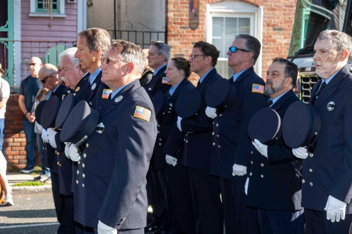 Sea Cliff first responders stand in front of the village's 9/11 memorial clock.