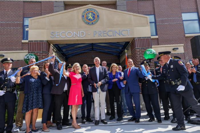 Bruce Blakeman (C.) cuts the ribbon at the Nassau County Police Department's 2nd Precinct in Woodbury.
