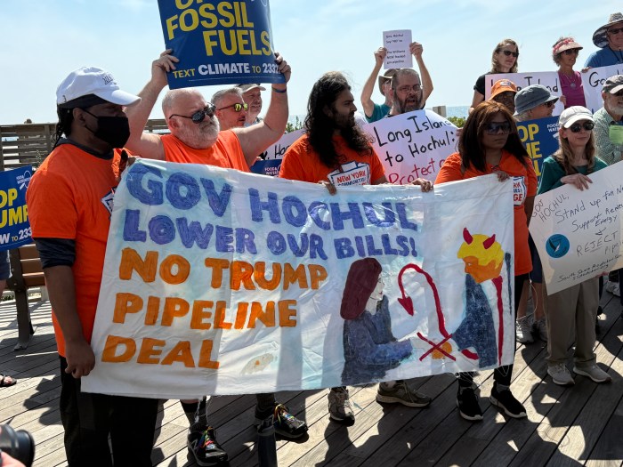 Protestors held signs calling out Gov. Kathy Hochul and the Trump administration.