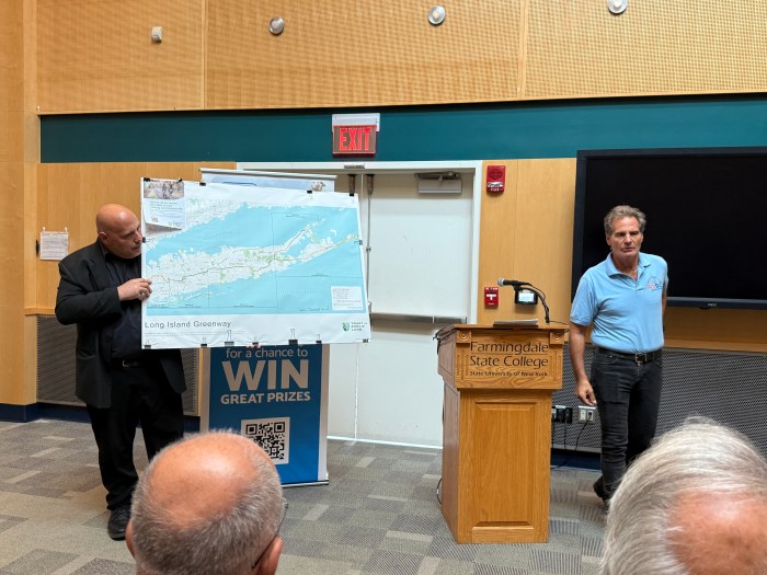 Eric Alexander, the executive director of Vision Long Island (L.), and Martin Buckman, an advocate for Friends of LI Greenway (R.) highlighting the proposed trails for the Long Island Greenway.