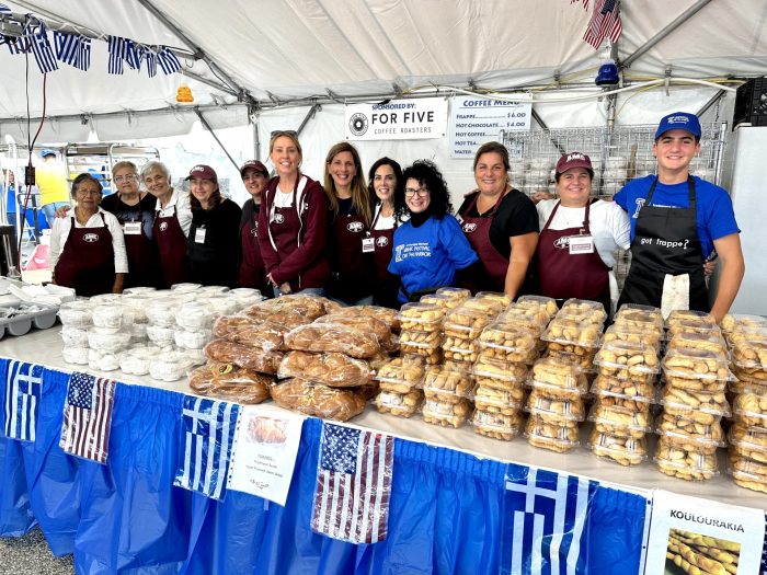 Volunteers help serve food at the Greek Festival on the Harbor.