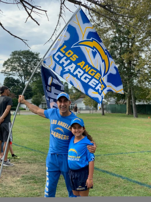 Ouzy Azoulay (L.) and his daughter Tess Azoulay (R.), spent the summer attending football games.
