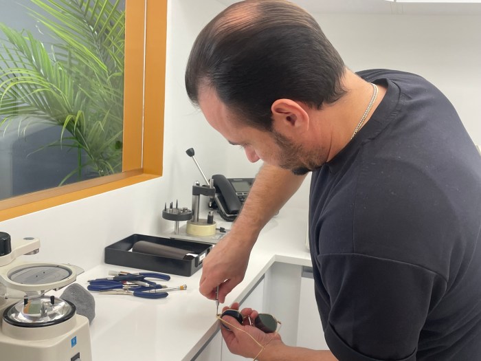 Chris Tsiplakos works on a pair of glasses at The Optical Shop of Manhasset.