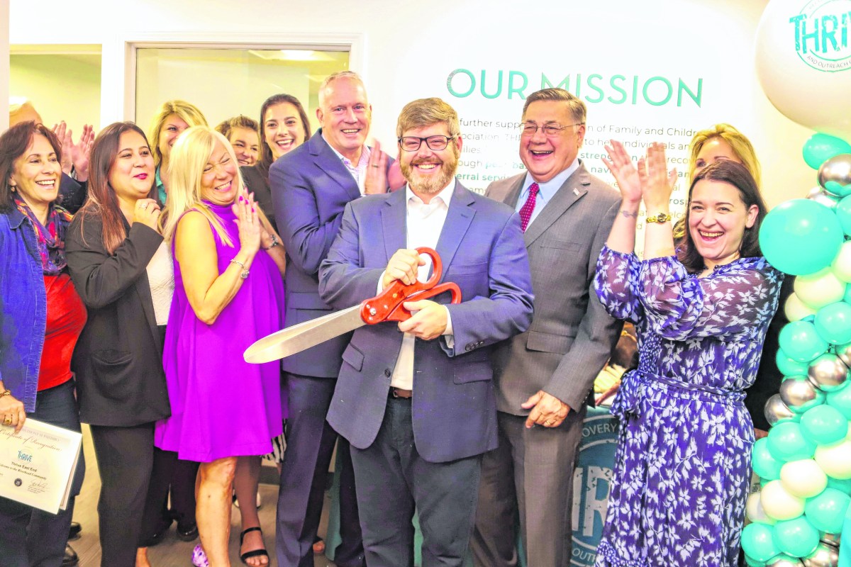 FCA’s Ryan Kiser (holding scissors), FCA President and CEO Dr. Jeffrey Reynolds (left), Suffolk County Executive Edward P. Romaine (right) and FCA staff and supporters celebrate opening another THRIVE center to help those in addiction recovery.