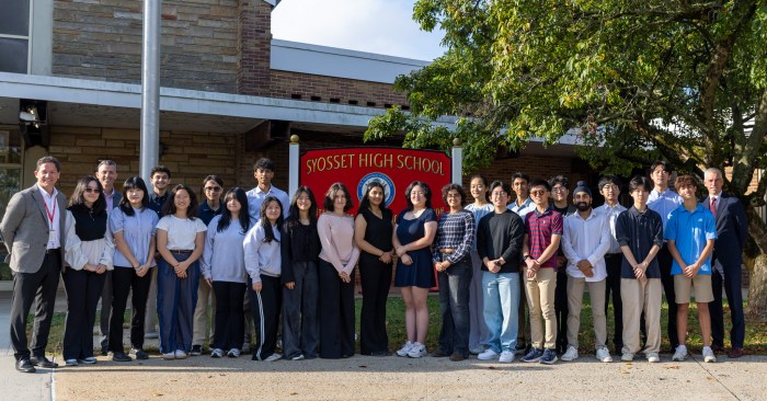 Syosset High School principal John Durante (Far L.) and Syosset Superintendent Thomas Rogers (Far R.) stand with the 24 seniors who were named National Merit semifinalists.