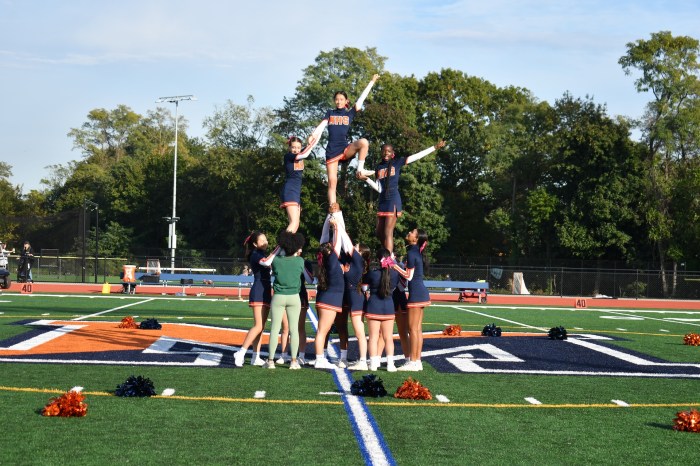 The high school cheer team performed during the homecoming halftime.