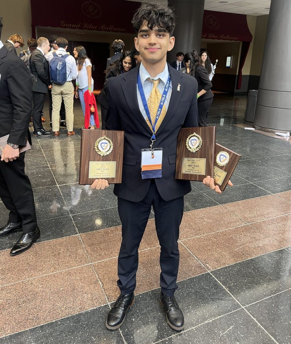 Dev Lakhani as a sophomore with his three state awards at New York State Future Business Leaders of America competition.
