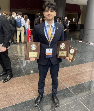 Dev Lakhani as a sophomore with his three state awards at New York State Future Business Leaders of America competition.