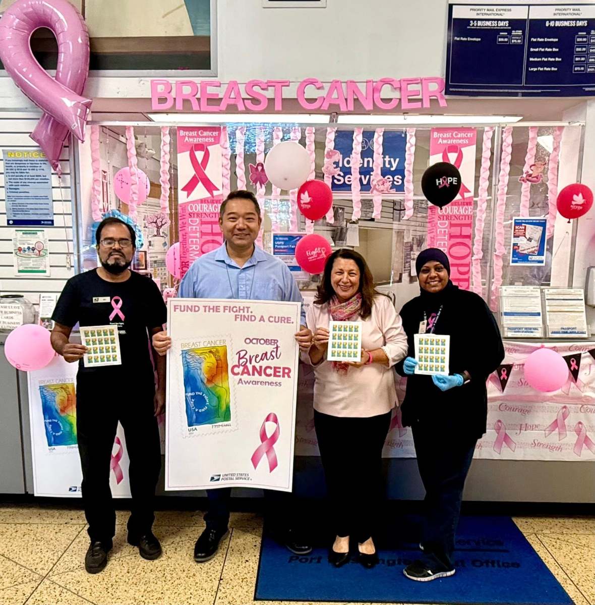 Council Member Mariann Dalimonte, Port Washington Postmaster Dominic Wong and post office workers in the Port Washington Post Office promoting Breast Cancer Awareness stamps.
