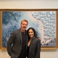 Dennis Leon (L.) and Natalia Good (R.) stand in front of Leon's paintings at the grand opening of Leon+Good Gallery in Locust Valley.