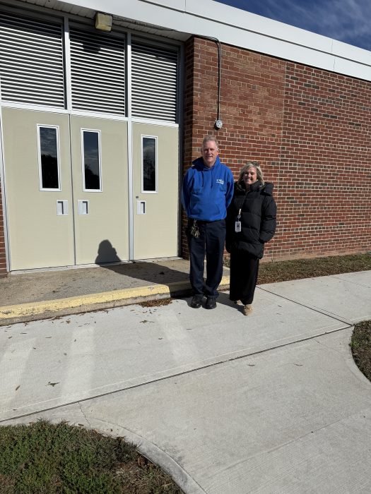 Old Country Road Elementary School Principal Laura McConnell and custodian Mark Hesse at the side entrance where the sidewalk was repaved.