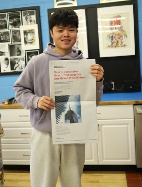 Tony Pan, a Jericho high schooler, poses with his photo in the New York Times.