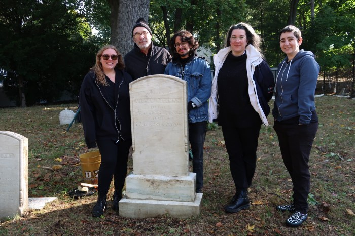 History Center’s Head Archivist, Liz Agramonte, archivists Amanda Hellburg and Joey Venutra, Head of Computer and Technology Services Melanie Davidoff, along with Town Historian for the Town of North Hempstead and Cow Neck Peninsula Historical Society Trustee Ross Lumpkin at Monfort Cemetery.